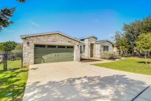 a house with a garage with a driveway at Cozy Lago Vista Home with Private Pool Table, Mile From The Stunning Lake Travis in Lago Vista