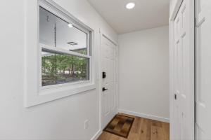 a hallway with white walls and a window at Maevebrook in Sister Bay