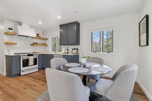 a kitchen with a table and chairs in a room at Maevebrook in Sister Bay +35 photos