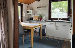 a kitchen with a wooden table in a tiny house at Amazing Home In Meschede With Wifi in Meschede