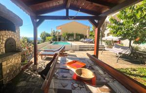 a patio with a table and a swimming pool at Apartment Ravni V in Labin