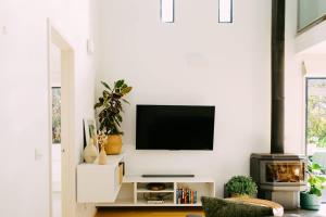 a living room with a tv on a white wall at Perfect Beachside Escape - Walk Everywhere in Anglesea