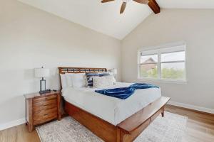 a bedroom with a large bed and a window at Spacious House with Ping-Pong and Pool Table, Balcony with Water and Sunset View in Point Venture