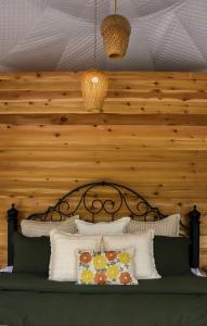 a bedroom with a bed with a wooden wall at Woodland Creek in Chase +21 photos