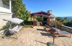 a patio with two chairs and a gazebo at Apartment Labin Ravni in Labin +38 photos
