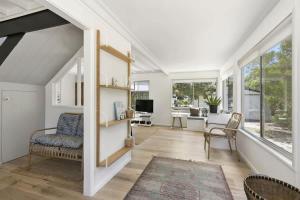 a living room with white walls and a large window at Beach at Your Doorstep - Pet Friendly in Anglesea