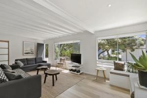 a living room with a couch and a tv at Beach at Your Doorstep - Pet Friendly in Anglesea