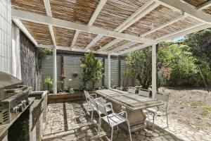 a patio with a table and chairs under a pergola at Beach at Your Doorstep - Pet Friendly in Anglesea