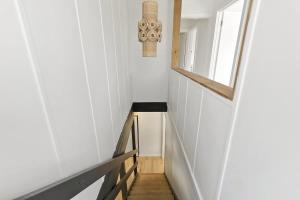 a staircase in a tiny house with a window at Beach at Your Doorstep - Pet Friendly in Anglesea