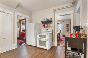 a kitchen with a stove and a refrigerator at Stowaway Lower Deck in Sturgeon Bay