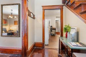 a hallway of a home with a mirror and a table at Stowaway Lower Deck in Sturgeon Bay +24 photos