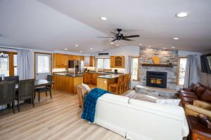 a living room with a white couch and a kitchen at Grateful Roots in Egg Harbor