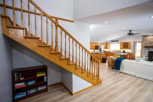 a staircase in a living room next to a kitchen at Grateful Roots in Egg Harbor