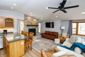 a kitchen and living room with a couch and a fireplace at Grateful Roots in Egg Harbor
