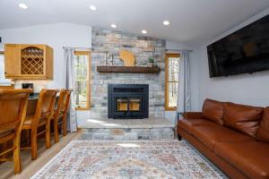 a living room with a couch and a fireplace at Grateful Roots in Egg Harbor +44 photos