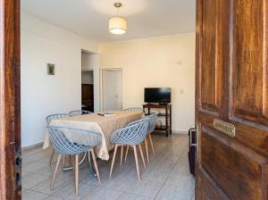 a dining room with a table and chairs and a television at Departamentos Marconi 1B in Resistencia