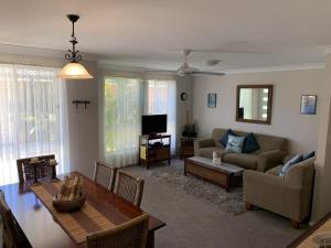 a living room with a couch and a table at Beach Haven Villa in North Haven