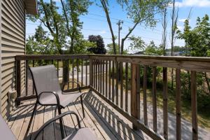 a white chair sitting on a deck at Upper Deck by Simple Life Rentals in Sturgeon Bay