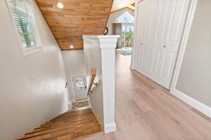 a staircase in a home with wood ceilings at Upper Deck by Simple Life Rentals in Sturgeon Bay