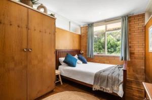 a bedroom with a bed and a window at Saltwinds - Steps to Beach & Lighthouse in Aireys Inlet