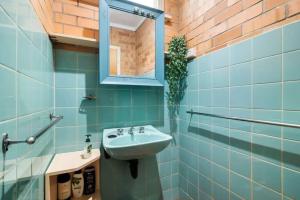 a bathroom with a sink and a mirror at Saltwinds - Steps to Beach & Lighthouse in Aireys Inlet