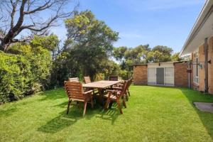 a table and chairs sitting on a lawn at Saltwinds - Steps to Beach & Lighthouse in Aireys Inlet