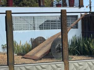 a picture of a wooden slide in a window at Pousada Carro de Boi in Lavras
