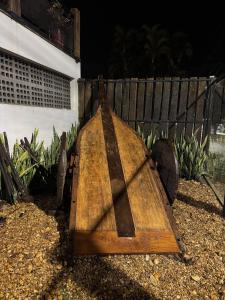 a wooden board sitting on the ground next to a fence at Pousada Carro de Boi in Lavras