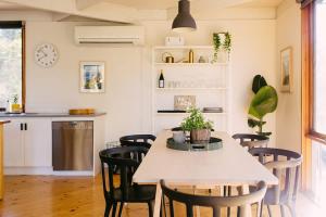 a kitchen and dining room with a table and chairs at The Angle House - Aireys Inlet in Aireys Inlet