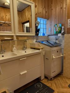 a kitchen with a sink and a counter top at 民泊利休 in Sakai
