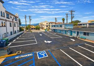 an empty parking lot with no parking signs in a town at Sea Garden Inn Pismo Beach- San Luis Obispo in Pismo Beach