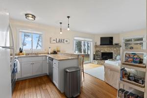 a kitchen and living room with a sink and a couch at Tranquility Bay Getaway by Simple Life Rentals in Sister Bay