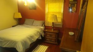 a bedroom with a bed and two lamps and a window at The Sparkle House in Cedar Rapids