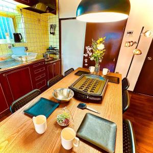 a kitchen with a table with a laptop on it at Between Kyoto & Osaka 渚南 駅徒歩3分 in Hirakata