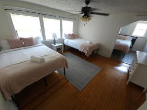 a bedroom with two beds and a ceiling fan at Huge 4-Bedroom Historic Home & Game Room in Goldsboro +41 photos
