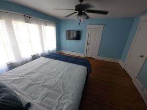 a bedroom with a bed and a ceiling fan at Huge 4-Bedroom Historic Home & Game Room in Goldsboro