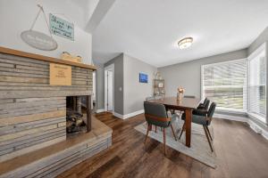 a dining room with a fireplace and a table and chairs at High Garden by Simple Life Rentals in Sister Bay