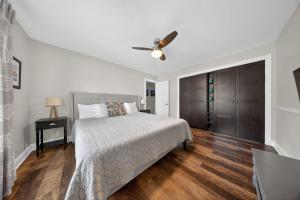 a bedroom with a bed and a ceiling fan at High Garden by Simple Life Rentals in Sister Bay +8 photos