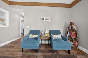 two blue chairs and a table in a living room at High Garden by Simple Life Rentals in Sister Bay