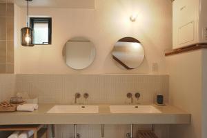 a bathroom with two sinks and two mirrors at TOKIWA葛城-katsuragi- in Shinjō