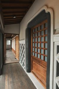 an entrance to a house with a wooden door at TOKIWA葛城-katsuragi- in Shinjō