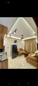 a living room with two couches and a tv at بورتو جولف in El Dab‘a