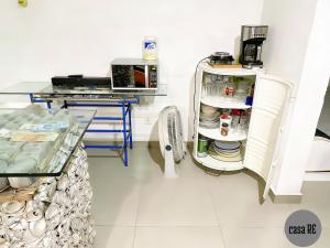 a kitchen with a refrigerator and a table at Habitación 2 Pitaya Casa RE in Tehuacán