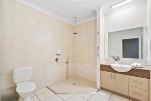a bathroom with a toilet and a sink at Emerald Inn by Travellers in Emerald +21 photos