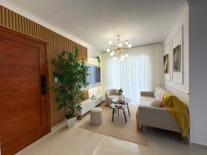 a living room with a couch and a plant at Comfort Home in La Cana