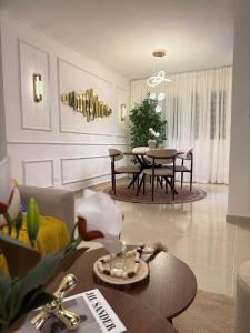 a living room with a table and a dining room at Comfort Home in La Cana