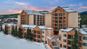 a group of buildings with snow on the roofs at Mountain Valley Lodge Resort Studio Villa in Breckenridge