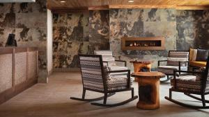 a lobby with rocking chairs and a fireplace at Mountain Valley Lodge Resort Studio Villa in Breckenridge