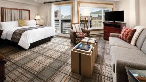 a hotel room with a bed and a tv at Mountain Valley Lodge Resort Studio Villa in Breckenridge