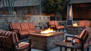 a patio with chairs and a fire pit with fires at Mountain Valley Lodge Resort Studio Villa in Breckenridge +11 photos
